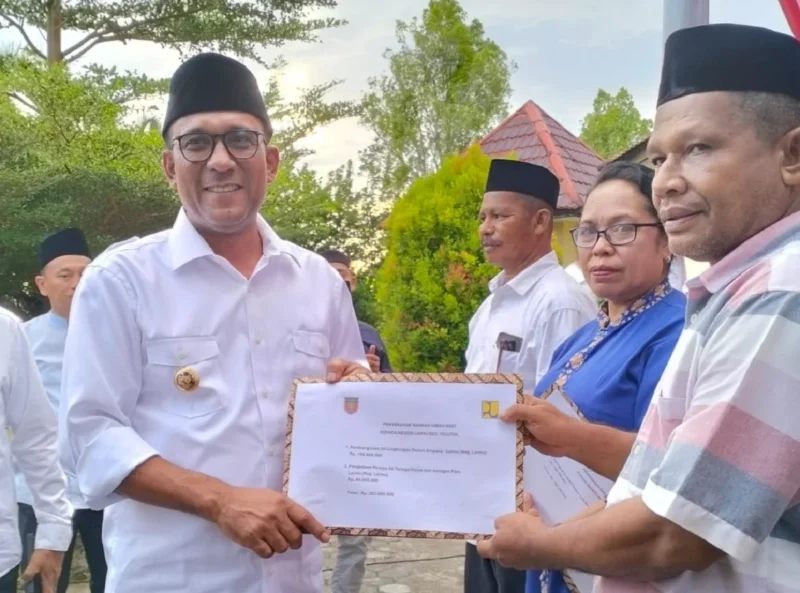 Bupati Malteng Zulkarnain Awat Amir saat menyerahkan bantuan dana hibah kepada sejumlah negeri di Kecamatan Teluti (Detik Indonesia/Berita Beta)